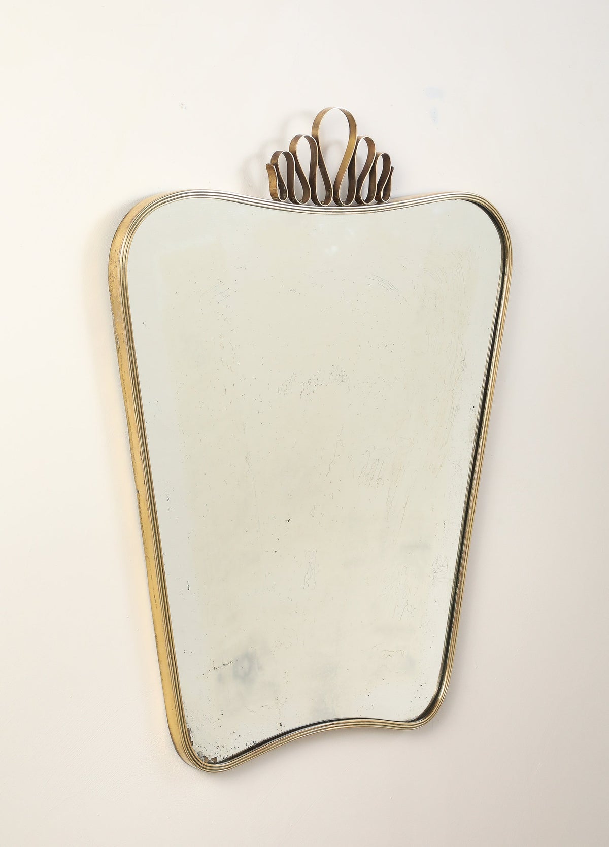 Luigi Fontana 1940's Brass Shaped Wall Mirror with Decorative Scroll Crest